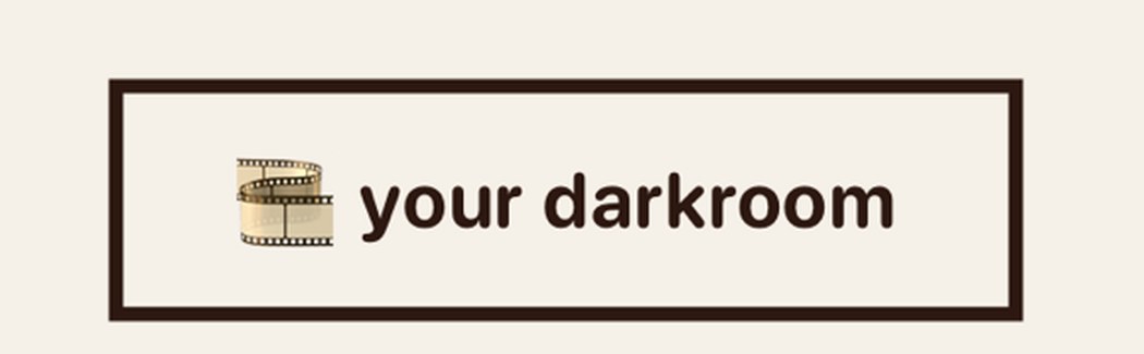 The your darkroom button from the Philmm home screen, a film reel icon inside a heavy dark brown rectangular border