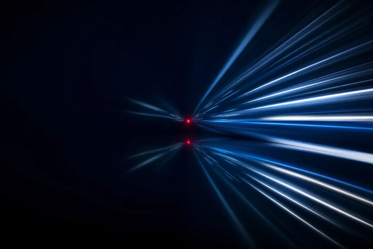 A single sharp red point of light held still in a dark field while pale blue streaks of light converge on it in motion blur